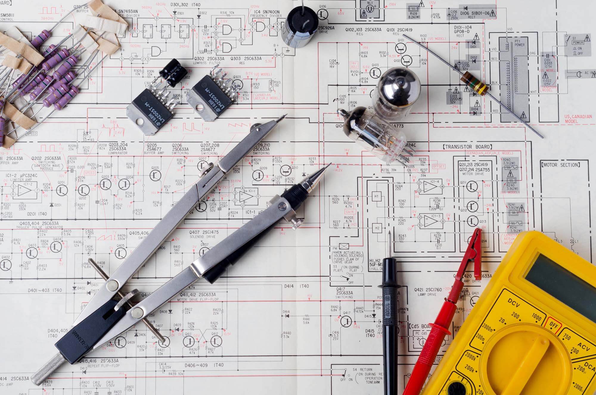 Electrical components and tools resting on an electrical wiring blueprint